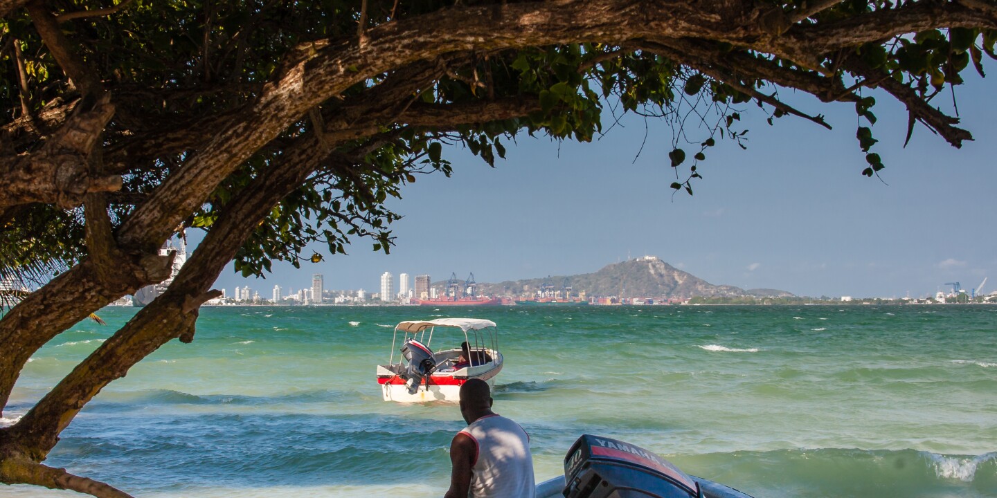 Small boat approaching Tierra Bomba, with Cartagena in background