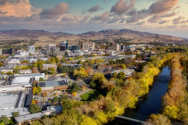 Fall in the city of trees with Boise River and downtown buildings