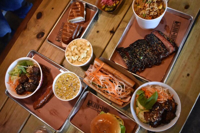 Banh mi, brisket, and a spread of sides at Blood Bros. BBQ.