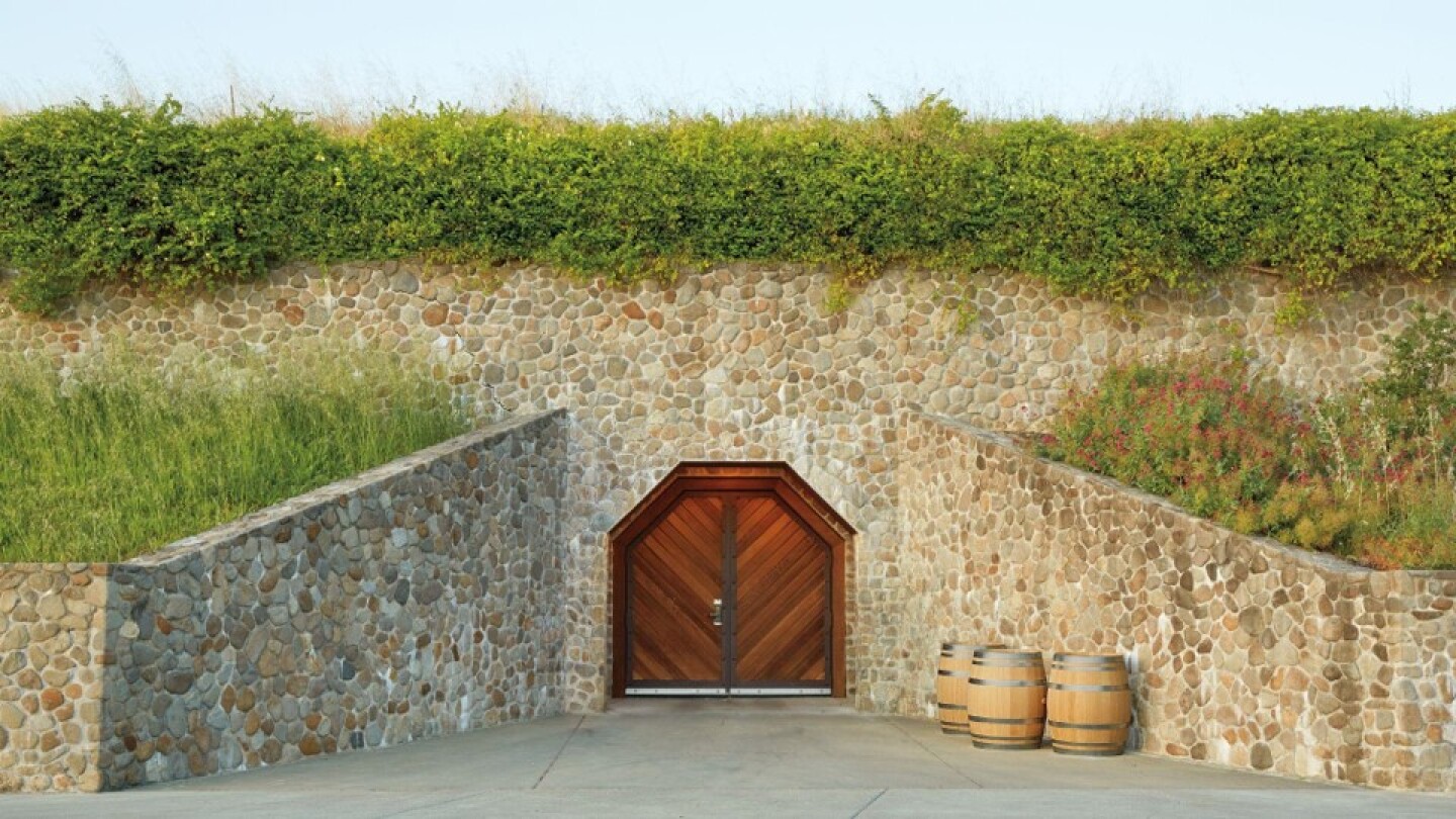 A view of a stone wall and wooden doors of Sonoma-Cutrer's wine cellar in Sonoma County, California.