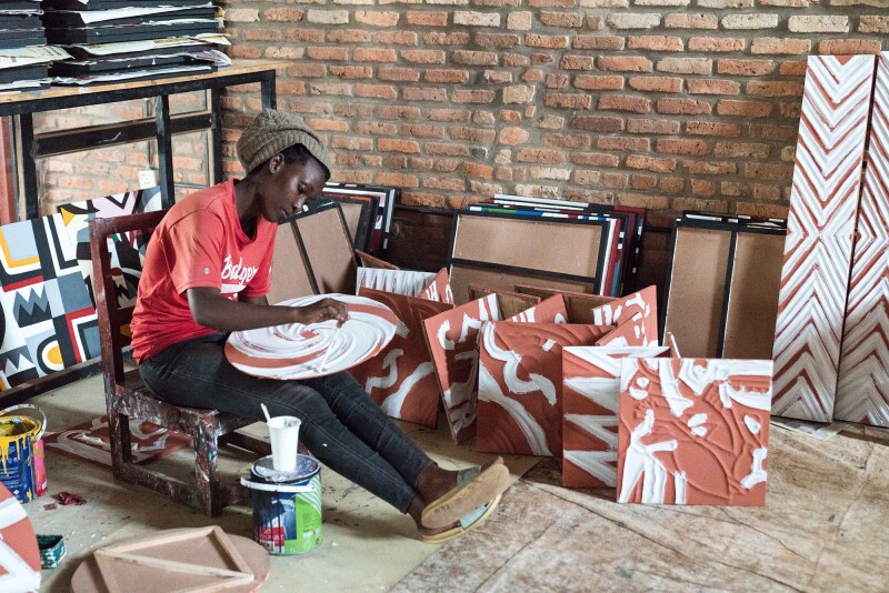 An artist at the Imigongo Art Center. Although supposedly invented by a prince, imigongo has traditionally been a women’s art form.