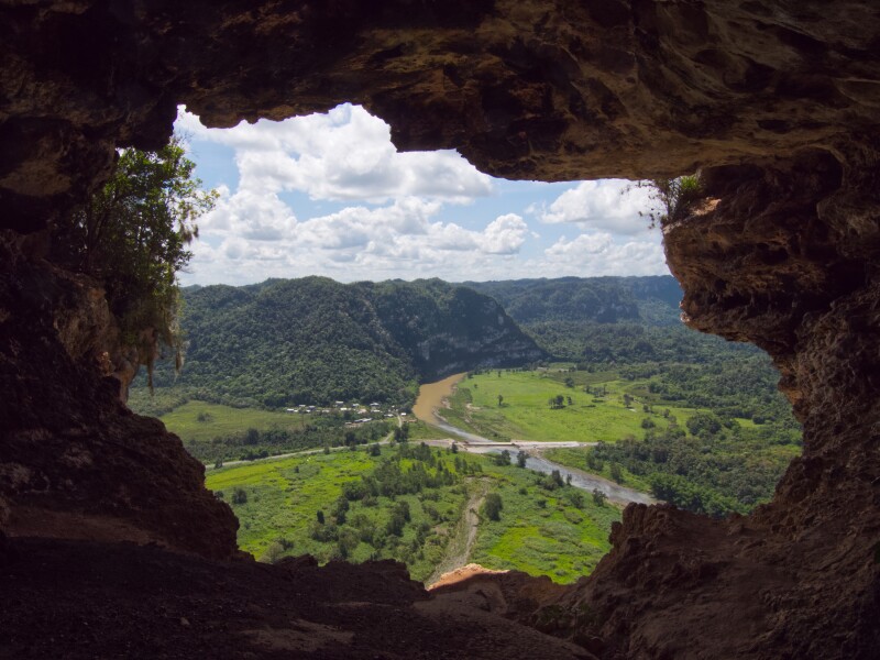 View of green landscape from inside Cueva Ventana natural window cave