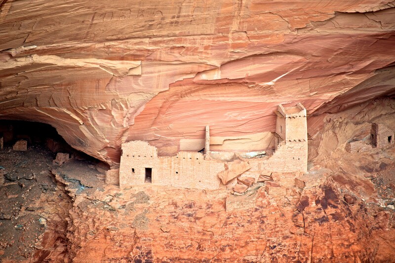 Mummy Cave, the largest ancient Puebloan village preserved in Canyon de Chelly, is carved into the cliffside