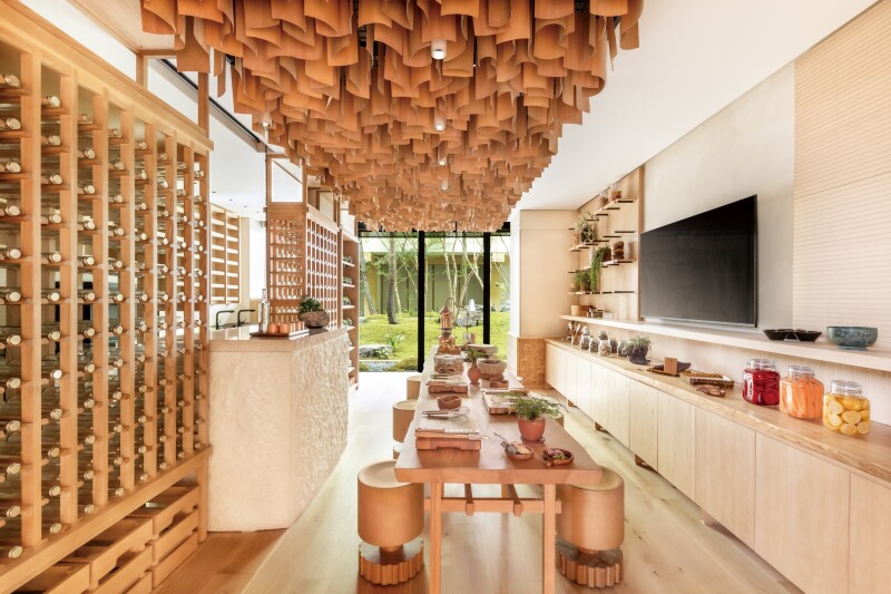 The Earth Lab at Six Senses Kyoto is clad in pale wood, with hanging wooden ceiling features