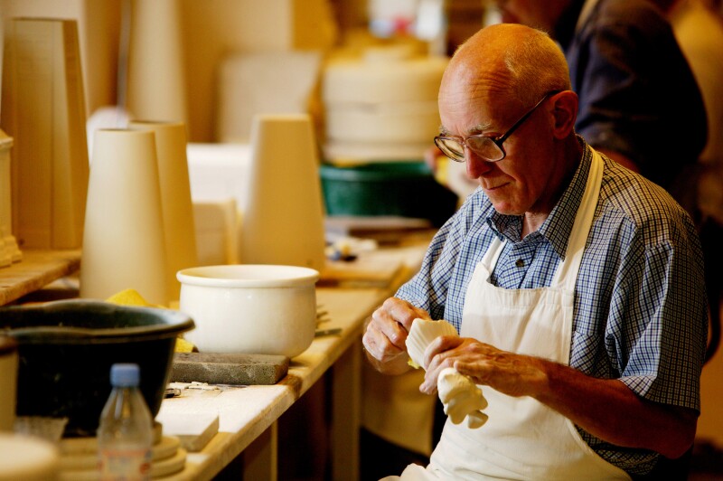 Picture of a craftsman working on a pottery piece at Belleek.
