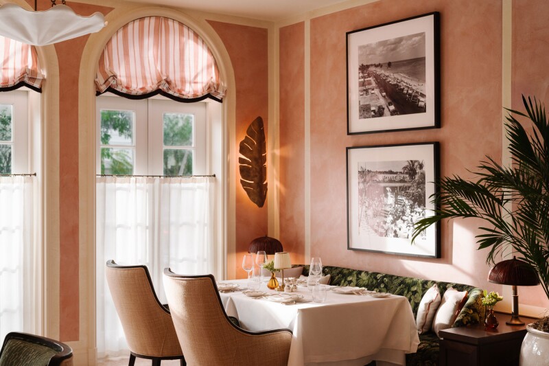 Vineta Hotel dining area with pink walls and black-and-white photos