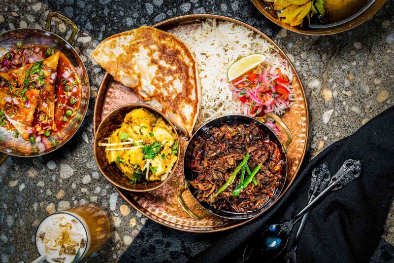 Overhead view of small bowls of Pakistani food at Ma'am Saab i