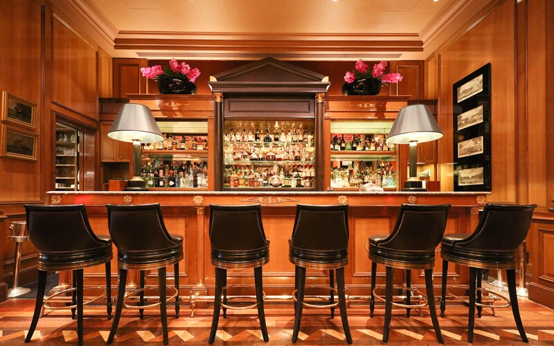 The bar at Four Seasons George V, with six chairs in front of it