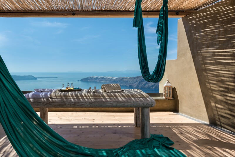 Shaded outdoor deck at Kallos Spa at Andronis Concept Wellness Resort, with distant views of Greek islands