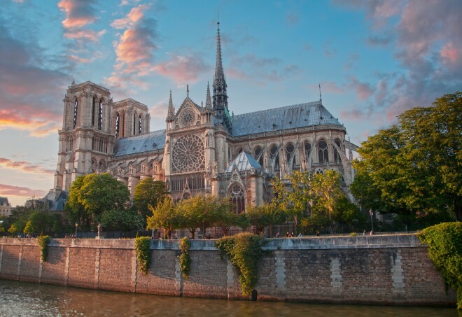 Notre Dame Cathedral in Paris, France, a side view from the river at sunset