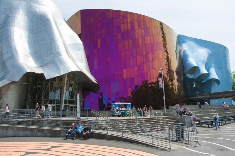 Exterior of Museum of Pop Culture, with wavy silver, multi-color, and wavy blue designs by Frank Gehry