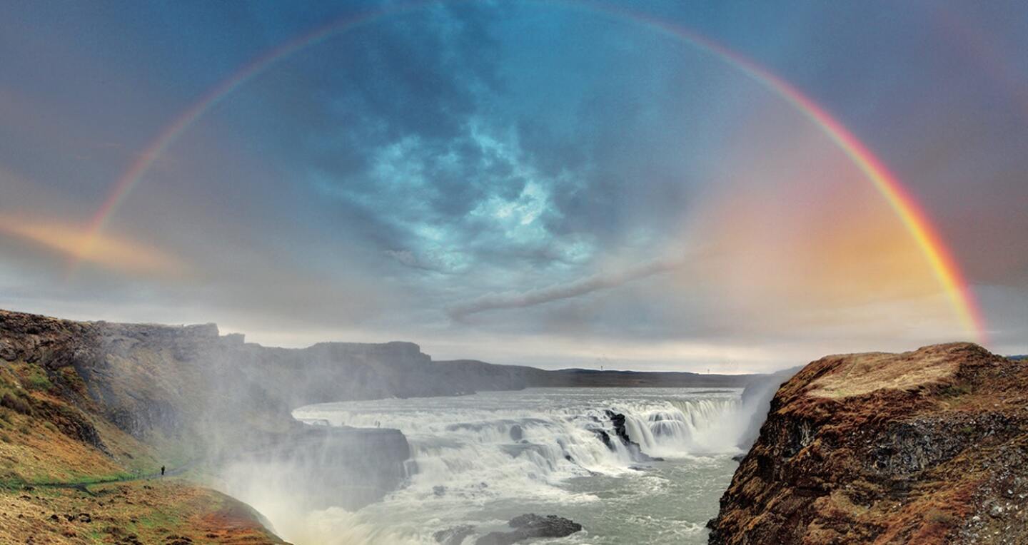 A rainbow over a canyon of waterfalls