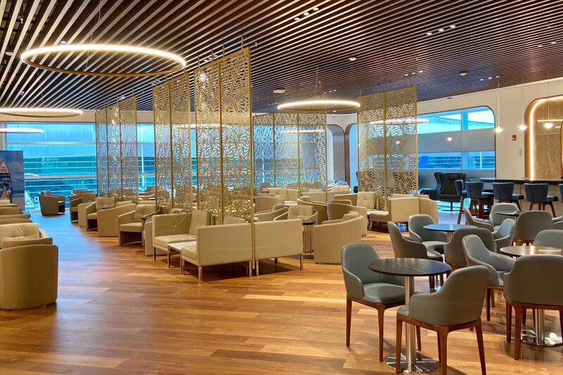 Beige and gray seating at large Turkish Airlines Lounge at Miami International, South Terminal Concourse H, with large windows