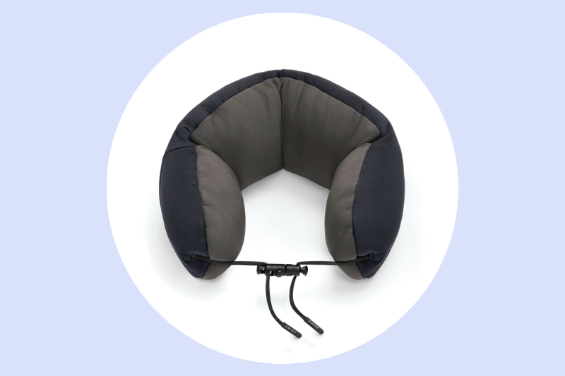 The Away neck pillow is available in black, navy, and green.