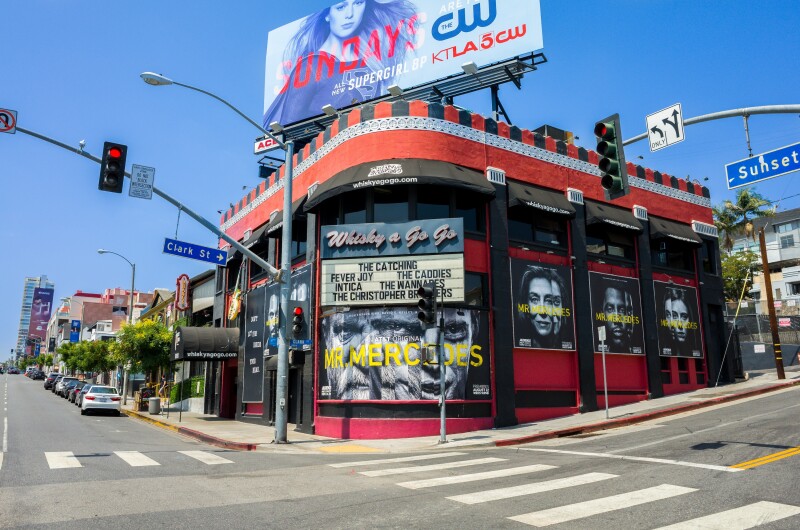 Side view of the famous Whisky a Go Go nightclub on the Sunset Strip in Hollywood. Black and red wall with advertisement. Launching pad for KISS