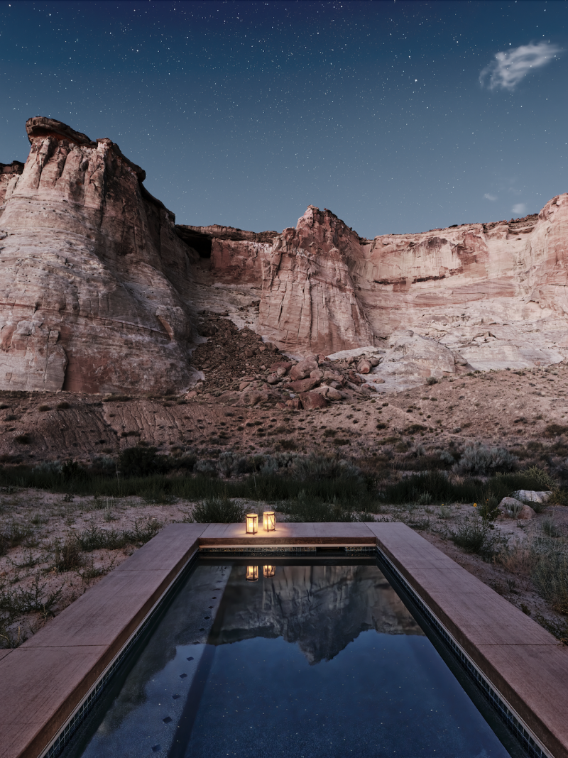 A plunge pool at night, with a mesa in the background