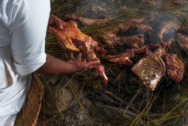 Preparing <i>haneeth</i>, a slow-roasted lamb dish