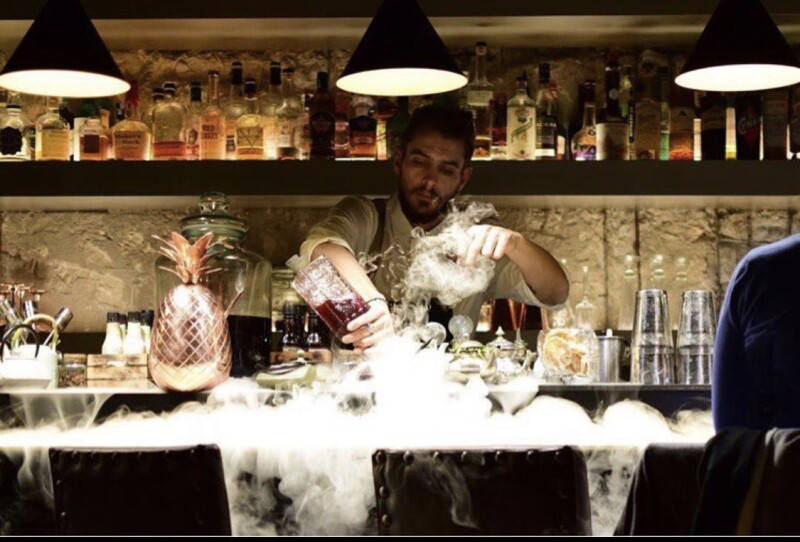 Part mixologist, part mad scientist, the Double 9 bartender prepares a tea-infused concoction.