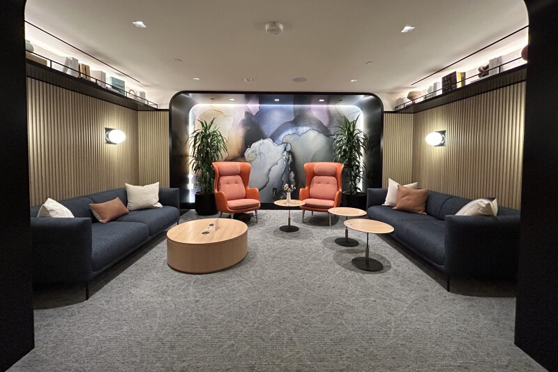 Chase Sapphire airport lounge with blue seating and a curved mezzanine at LaGuardia Airport