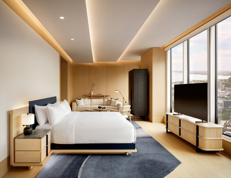 A Hikari Corner Suite, with floor-to-ceiling windows, blond wood floor, and gray rug