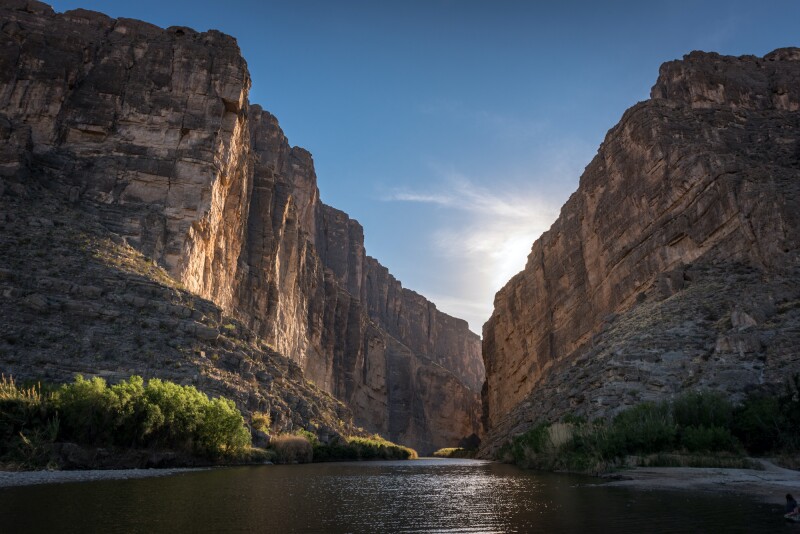 Flat Rio Grande passing between cliffs