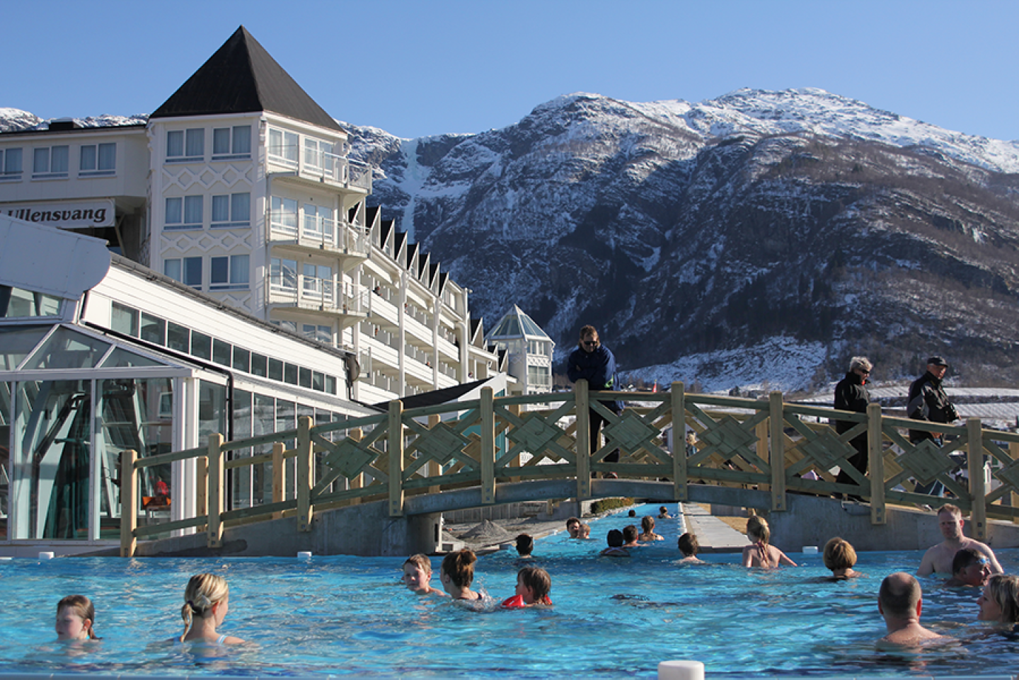 A large outdoor pool with about 20 people at Hotel Ullensvang