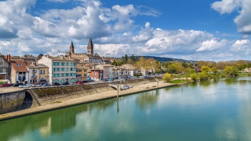 Trees and buildings along the river in Tournus, France