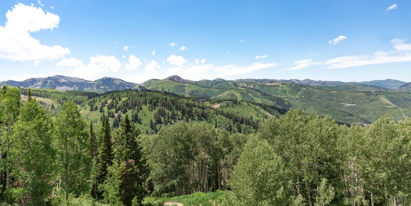 Lush greenery covers an expansive landscape of rolling hills and mountaintops