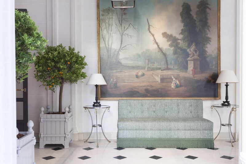 Part of lobby of iconic Le Bristol Paris, with pale green sofa under large painting