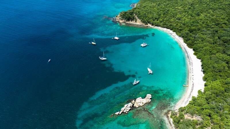 Aerial view of a coastline with boats in the water