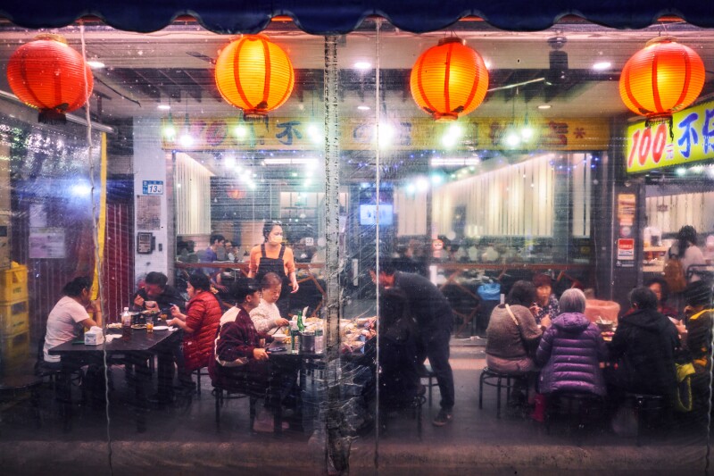 Exterior of a rechao place with diners at night