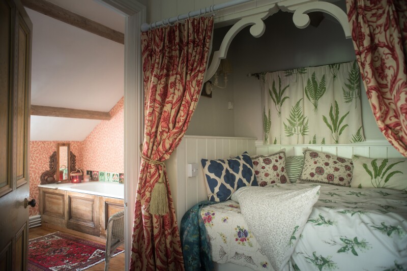 Cozy bedroom with botanical-printed linens inside an Airbnb in Wales