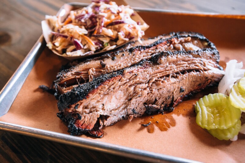 Brisket, coleslaw, and pickles on tray at the Pecan Lodge