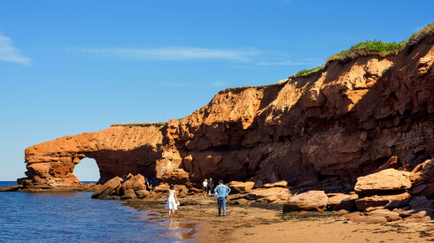 Beach with stone formation on a sunny day.
