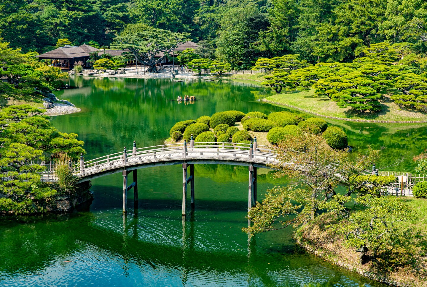 Small bridge over large pond in Ritsurin Garden in the port city of Takamatsu