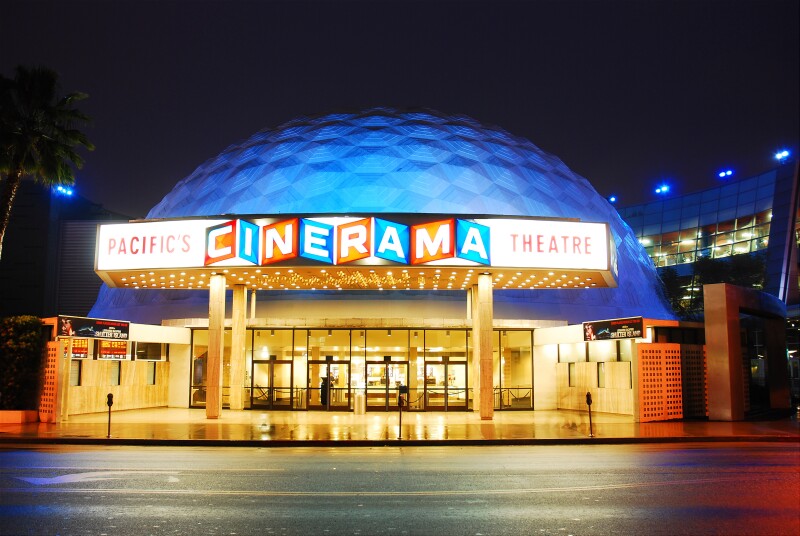 The Cinerama Theater of Hollywood, California lit up at night.
