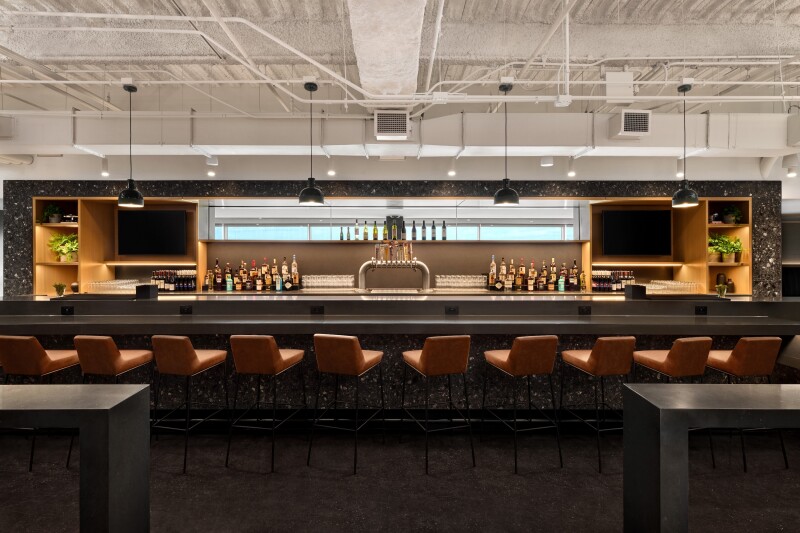 A long bar at the newly reopened United lounge at Denver airport