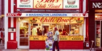 Man walking past Ben's Chili Bowl