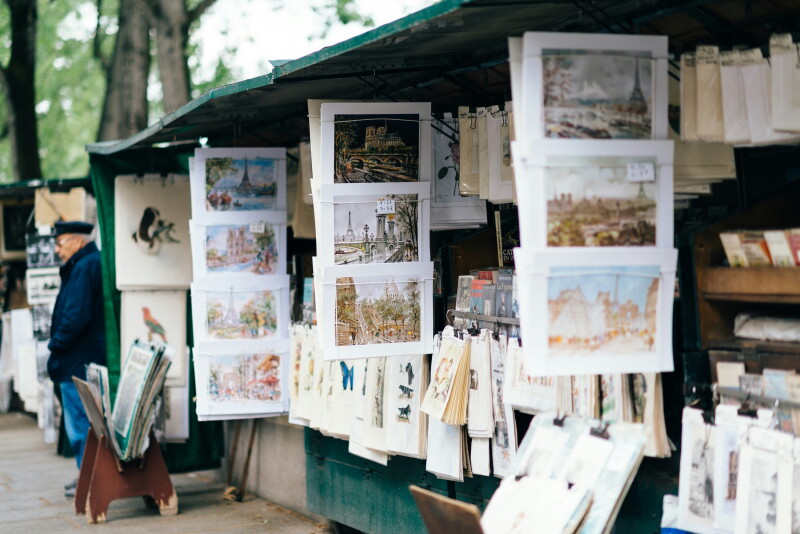 Drawings and paintings on display among green wooden stands that line the Seine River in Paris
