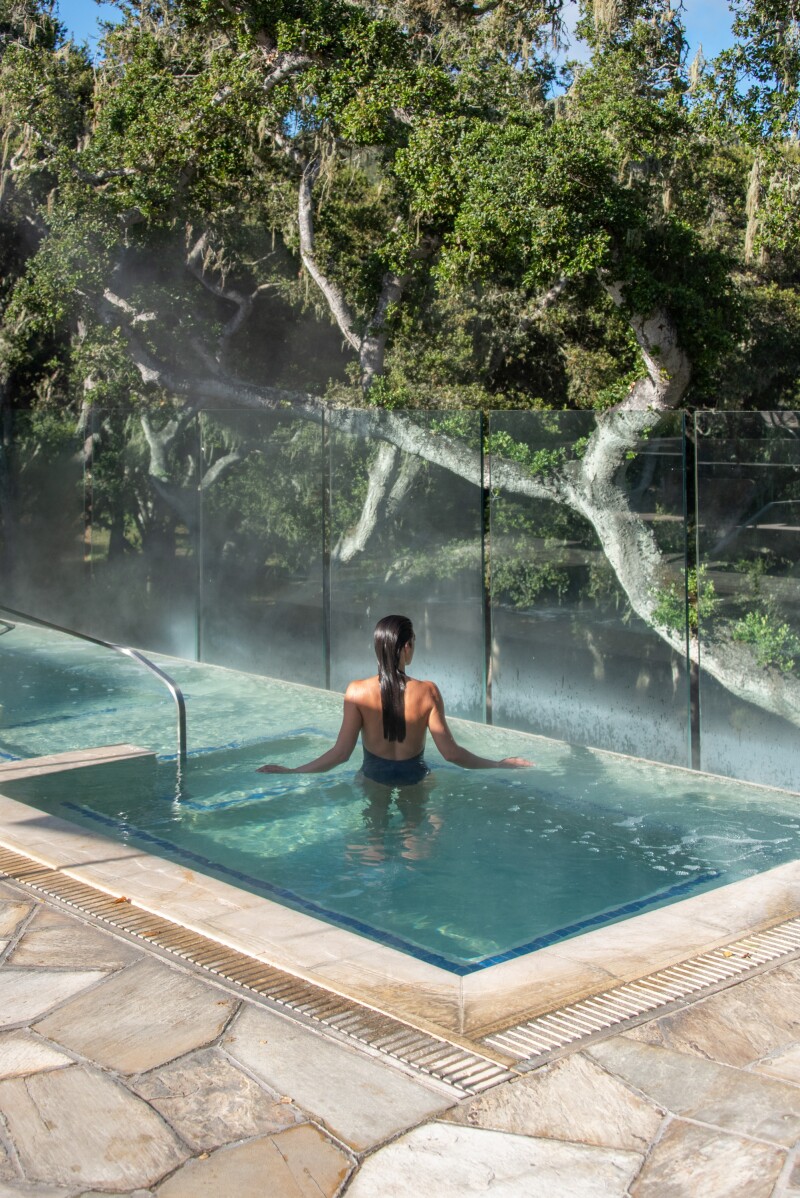 A woman relaxing in an outdoor spa at Carmel Valley Ranch