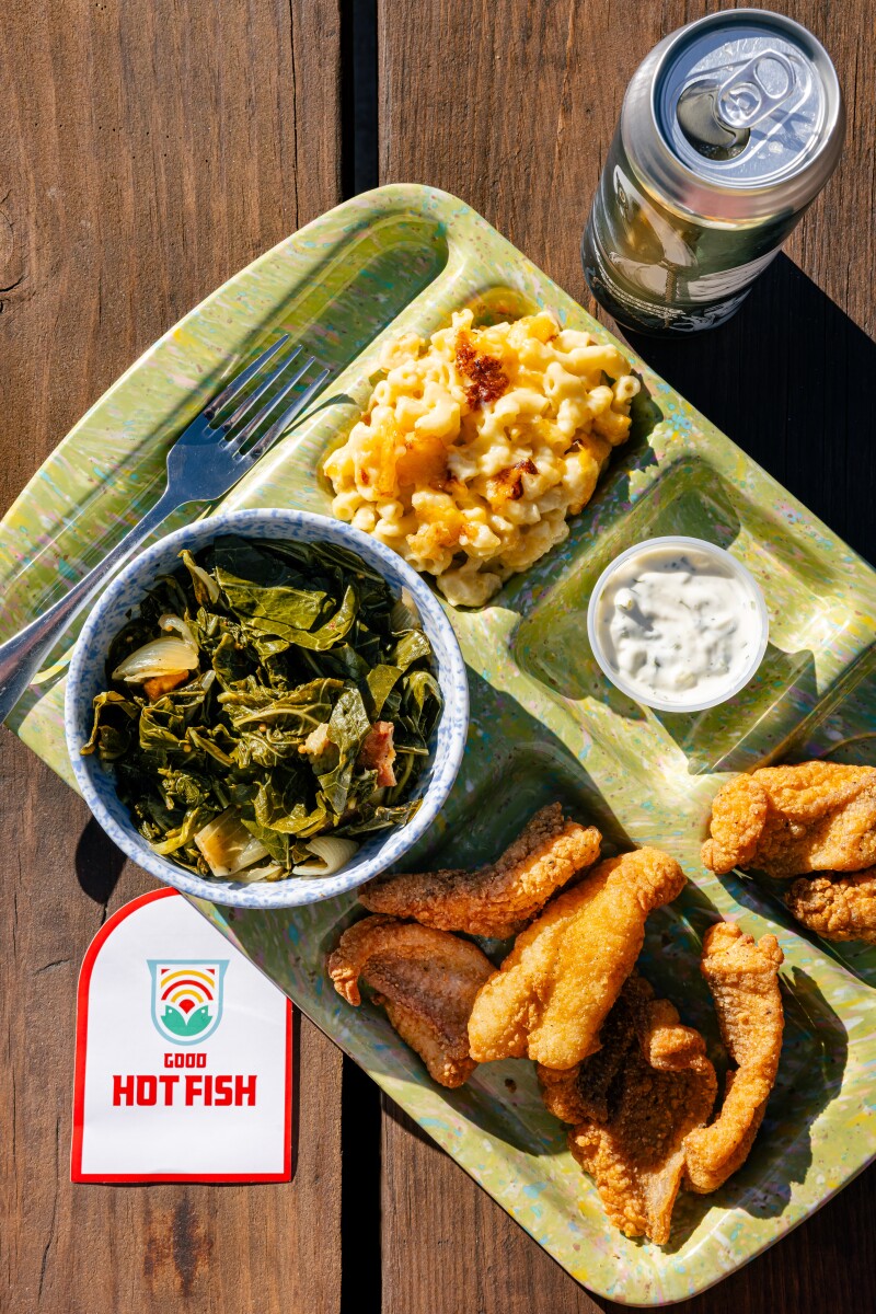 A photo of a cafeteria style tray of food from Good Hot Fish on a picnic table in Asheville