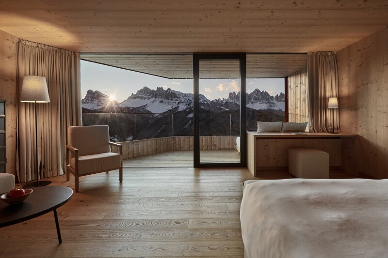 This suite at Forestis in Italy's Dolomites region features a private balcony with mountain views.