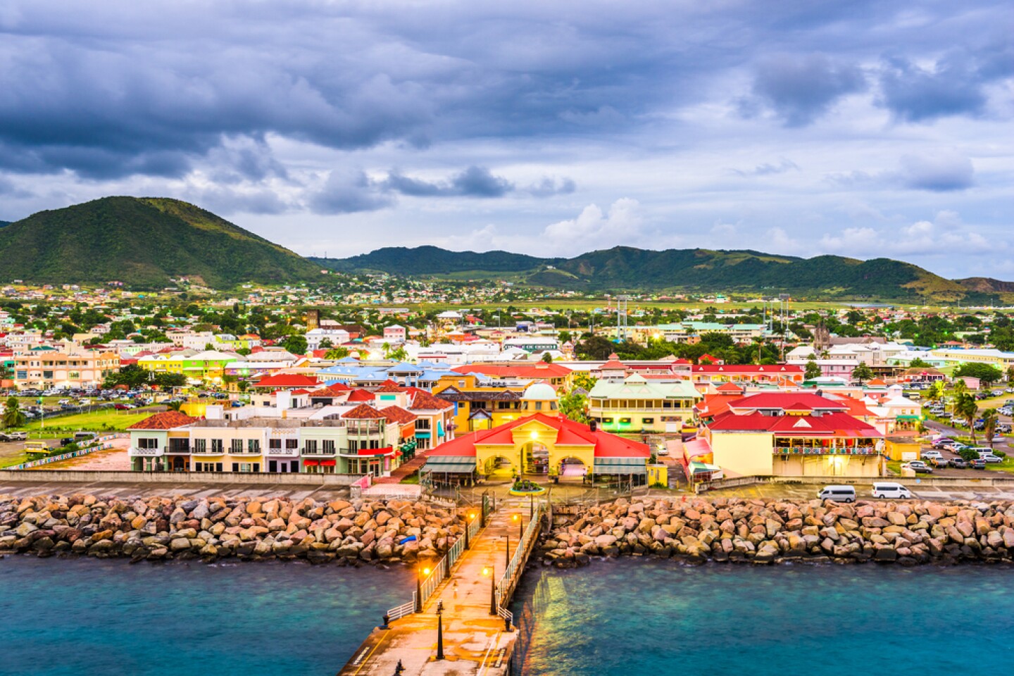 Multicolored houses in front of a boardwalk to the ocean