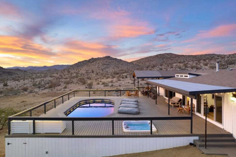 Airbnb with large pool deck at sunset in the desert near Joshua Tree National Park