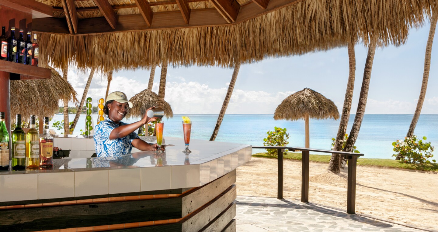 Enjoy handcrafted drinks at the resort’s barefoot beach bar, Coral Reef.