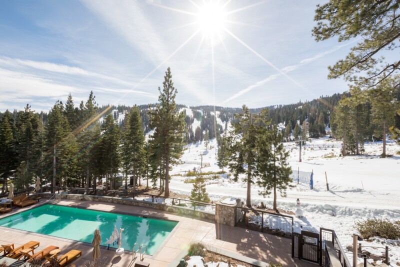 The Ritz-Carlton, Lake Tahoe's pool is shaded by evergreen trees.