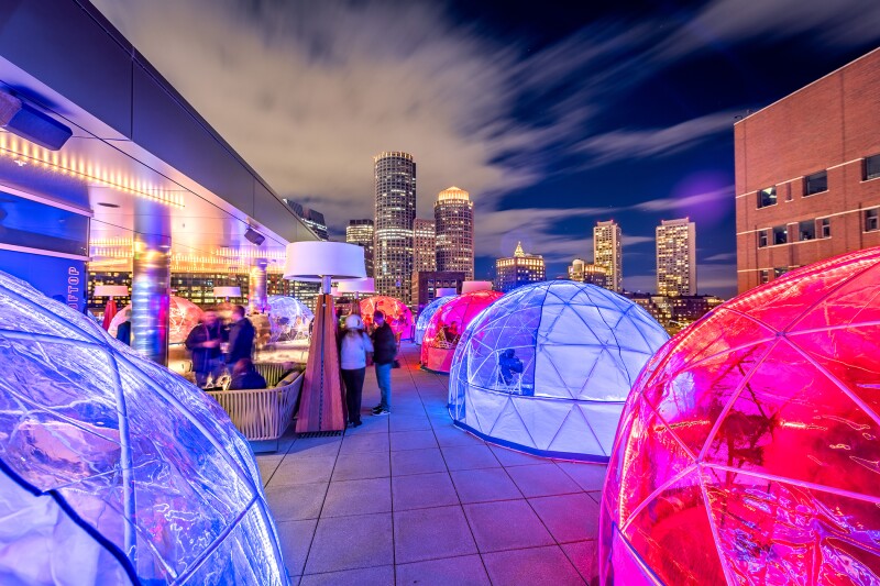 Hunker down for Boston's winter chills in a heated and illuminated igloo atop The Envoy Hotel.