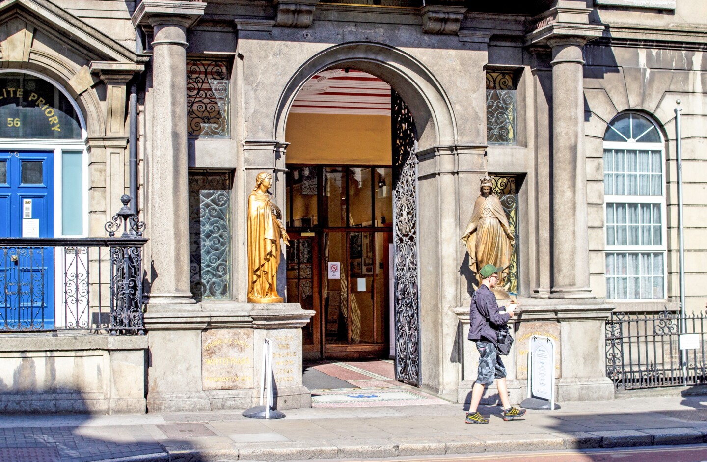 The arched entrance to the Whitefriar Street Church, flanked by a robed statue on each side