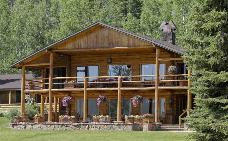 The two-story main lodge at C Lazy U Ranch, built of logs found on the property, with balcony