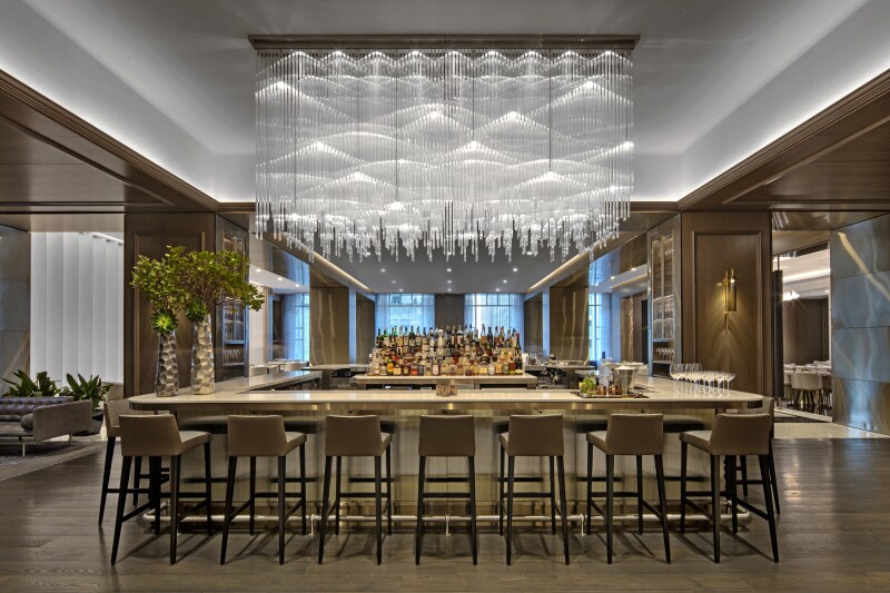 The bar at Adorn Bar & Restaurant, with a striking, large glass chandelier